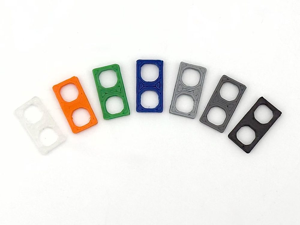 Minifig Spacers — One design, seven materials. Changing colour costs a spool, not a mold