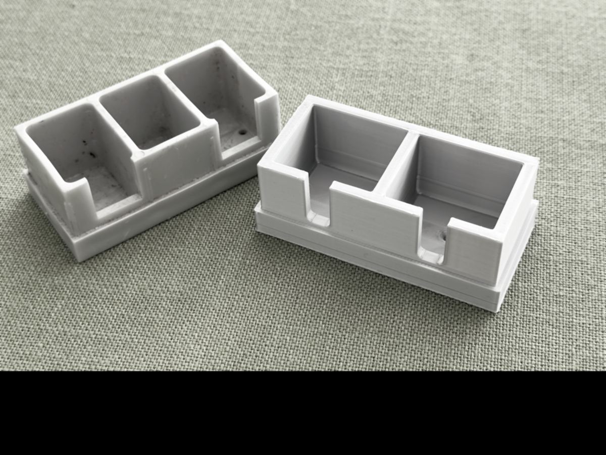 A printed replacement tool foot beside the worn original it copies