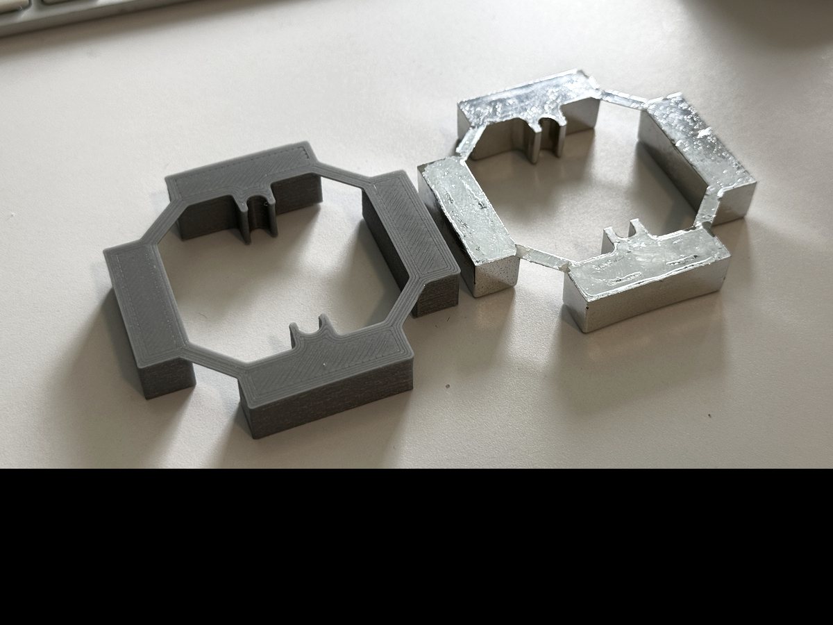 A printed replacement ring beside the broken metal original